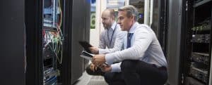 two men looking at a server